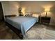 Comfortable bedroom with a large bed, lamps, and gray carpet at 8908 Legacy Ct # 303, Kissimmee, FL 34747