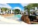 Beautiful zero entry community pool area with palm trees and rock features at 8908 Legacy Ct # 303, Kissimmee, FL 34747