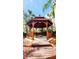Charming gazebo with seating surrounded by lush tropical landscaping at 8908 Legacy Ct # 303, Kissimmee, FL 34747