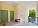 A building hallway with green doors, seating, and stairway at 8908 Legacy Ct # 303, Kissimmee, FL 34747