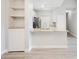 A bright, open kitchen featuring modern white cabinets, stainless steel appliances, and a breakfast bar with granite countertops at 8908 Legacy Ct # 303, Kissimmee, FL 34747