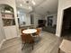 An open-concept living room featuring a modern dining set, kitchen bar, and a comfy sectional sofa at 8908 Legacy Ct # 303, Kissimmee, FL 34747