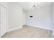 An open living space with gray wood flooring, a stylish light fixture, and neutral walls at 8908 Legacy Ct # 303, Kissimmee, FL 34747