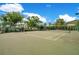 Outdoor tennis court surrounded by lush tropical landscaping at 8908 Legacy Ct # 303, Kissimmee, FL 34747