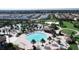 Aerial view of community pool, clubhouse, palm trees and common areas at 8993 Cabot Cliffs Dr, Davenport, FL 33896