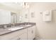 This bathroom offers double sinks, grey countertops and a large mirror at 8993 Cabot Cliffs Dr, Davenport, FL 33896
