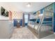 This themed bedroom features a bunk bed, wall decor, and gray dresser at 8993 Cabot Cliffs Dr, Davenport, FL 33896