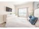 Bright bedroom with a white bed, soft blue accents, and a TV for relaxing evenings at 8993 Cabot Cliffs Dr, Davenport, FL 33896