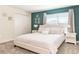 This bedroom features neutral carpet, an accent wall, and a king bed with white linens at 8993 Cabot Cliffs Dr, Davenport, FL 33896