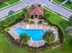 Aerial view of community pool with lounge chairs and lush landscaping at 913 Bending Oak Trl, Winter Garden, FL 34787