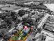 Aerial view of a property in a residential neighborhood with mature trees and a nearby pond at 913 Bending Oak Trl, Winter Garden, FL 34787