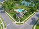 Aerial view of a community clubhouse with a swimming pool and lake at 913 Bending Oak Trl, Winter Garden, FL 34787