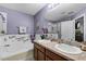 Bathroom with double sinks, jacuzzi tub, and decorated with flowers at 913 Bending Oak Trl, Winter Garden, FL 34787