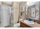 A bathroom with a glass-enclosed shower, wooden vanity, and decorative accents for a relaxing atmosphere at 913 Bending Oak Trl, Winter Garden, FL 34787