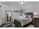 Bedroom with a full-length mirror and wooden bedframe at 913 Bending Oak Trl, Winter Garden, FL 34787