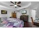 Comfortable bedroom with a ceiling fan and dresser with a TV at 913 Bending Oak Trl, Winter Garden, FL 34787