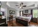 A primary bedroom suite with ceiling fan, tray ceiling, and ensuite bath access at 913 Bending Oak Trl, Winter Garden, FL 34787
