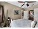 Comfortable bedroom featuring an antique mirror and side table with neutral decor at 913 Bending Oak Trl, Winter Garden, FL 34787