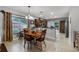 An open dining area boasts tile flooring, a wooden table, and a view into the adjacent kitchen at 913 Bending Oak Trl, Winter Garden, FL 34787