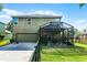 Two-story house with a screened-in patio and a spacious backyard with a fence, great for outdoor activities at 913 Bending Oak Trl, Winter Garden, FL 34787