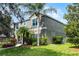Side exterior view of home with lush landscaping, well-maintained lawn, and mature trees at 913 Bending Oak Trl, Winter Garden, FL 34787