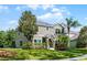 Charming two-story home with lush landscaping, mature trees, and well-maintained lawn at 913 Bending Oak Trl, Winter Garden, FL 34787