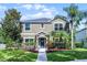Charming two-story home with a well-manicured lawn and lush landscaping at 913 Bending Oak Trl, Winter Garden, FL 34787