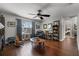 Cozy living room features hardwood floors, a ceiling fan, and ample natural light at 913 Bending Oak Trl, Winter Garden, FL 34787