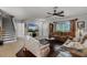 A cozy living room with hardwood floors, comfortable seating, and natural light from the large window at 913 Bending Oak Trl, Winter Garden, FL 34787