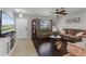 Cozy living room with wood floors, a ceiling fan, and ample natural light at 913 Bending Oak Trl, Winter Garden, FL 34787