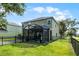 Rear exterior of home with a screened-in lanai and fenced yard at 913 Bending Oak Trl, Winter Garden, FL 34787