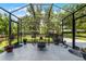 Screened lanai with comfortable seating and an outdoor fire pit at 913 Bending Oak Trl, Winter Garden, FL 34787