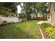 Well-manicured backyard with lush green grass, a concrete patio, and privacy fence perfect for outdoor entertaining at 9545 Southern Garden Cir, Altamonte Springs, FL 32714