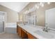 Main bathroom featuring double sinks, soaking tub, and a shower at 9545 Southern Garden Cir, Altamonte Springs, FL 32714
