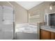 Bright bathroom with a shower and soaking tub combination, enhanced by natural light and a modern vanity at 9545 Southern Garden Cir, Altamonte Springs, FL 32714