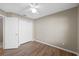 Bedroom featuring wood-look floors, a ceiling fan, and a closet, with an open door leading to another room at 9545 Southern Garden Cir, Altamonte Springs, FL 32714