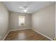 Neutral bedroom with wood floors, a window with blinds, and a ceiling fan at 9545 Southern Garden Cir, Altamonte Springs, FL 32714