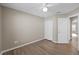 Bedroom featuring wood floors, a ceiling fan, and a closet, with an open door leading to another room at 9545 Southern Garden Cir, Altamonte Springs, FL 32714