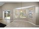 Bright breakfast nook features tile flooring, three windows, and access to the backyard through sliding glass doors at 9545 Southern Garden Cir, Altamonte Springs, FL 32714