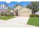 Well-maintained single-Gathering home featuring a two-car garage and manicured landscaping at 9545 Southern Garden Cir, Altamonte Springs, FL 32714