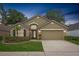 Charming single-story home with manicured lawn, two-car garage, and inviting front entrance at 9545 Southern Garden Cir, Altamonte Springs, FL 32714