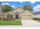 Charming single-story home with manicured lawn, two-car garage, and inviting front entrance at 9545 Southern Garden Cir, Altamonte Springs, FL 32714