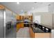 Bright kitchen with stainless steel appliances, granite countertops, and wood cabinets at 9545 Southern Garden Cir, Altamonte Springs, FL 32714