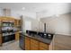 Open kitchen with granite countertops, stainless steel appliances, and a breakfast bar at 9545 Southern Garden Cir, Altamonte Springs, FL 32714