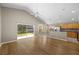 Open living area showcases wood floors, a sliding glass door, and a kitchen area with stainless steel appliances at 9545 Southern Garden Cir, Altamonte Springs, FL 32714