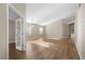 Expansive living room featuring hardwood floors, abundant natural light, and a view of the home's entry through french doors at 9545 Southern Garden Cir, Altamonte Springs, FL 32714
