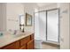 Bathroom with a vanity, framed mirror, and glass-enclosed shower at 1031 Marcello Blvd, Kissimmee, FL 34746