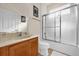 Well-lit bathroom featuring a vanity with a mirror and a shower with glass doors at 1031 Marcello Blvd, Kissimmee, FL 34746