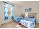 Charming bedroom featuring two twin beds, themed bedding, and natural light at 1031 Marcello Blvd, Kissimmee, FL 34746