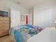 Bedroom featuring cartoon bedding, adjacent bathroom, and double door closet at 1031 Marcello Blvd, Kissimmee, FL 34746